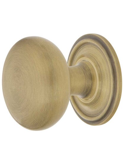 Classic Round Cabinet Knob - 1 3/8 inch Diameter with Matching Rosette in Antique Brass.